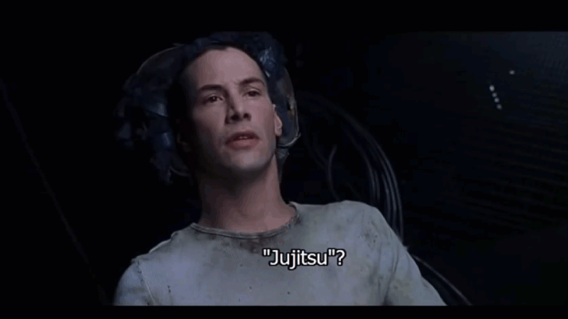 Gif loop scene from the movie The Matrix showing Tank uploading knowledge of jujitsu into Neo's brain.